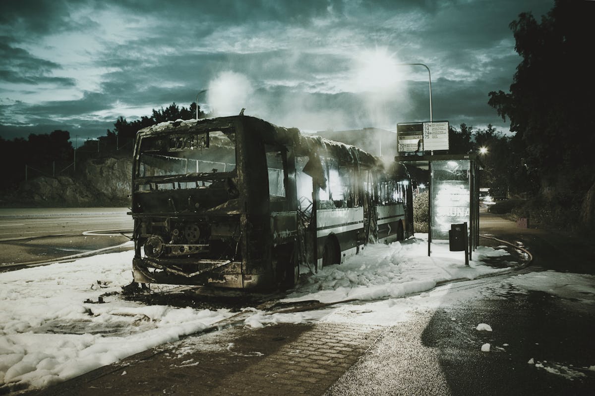 A bus is covered in snow and smoke