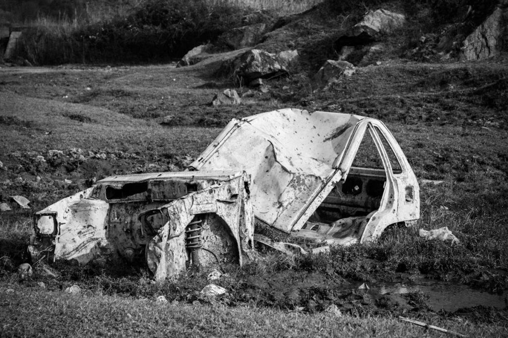 Abandoned Rusted Car in a Field