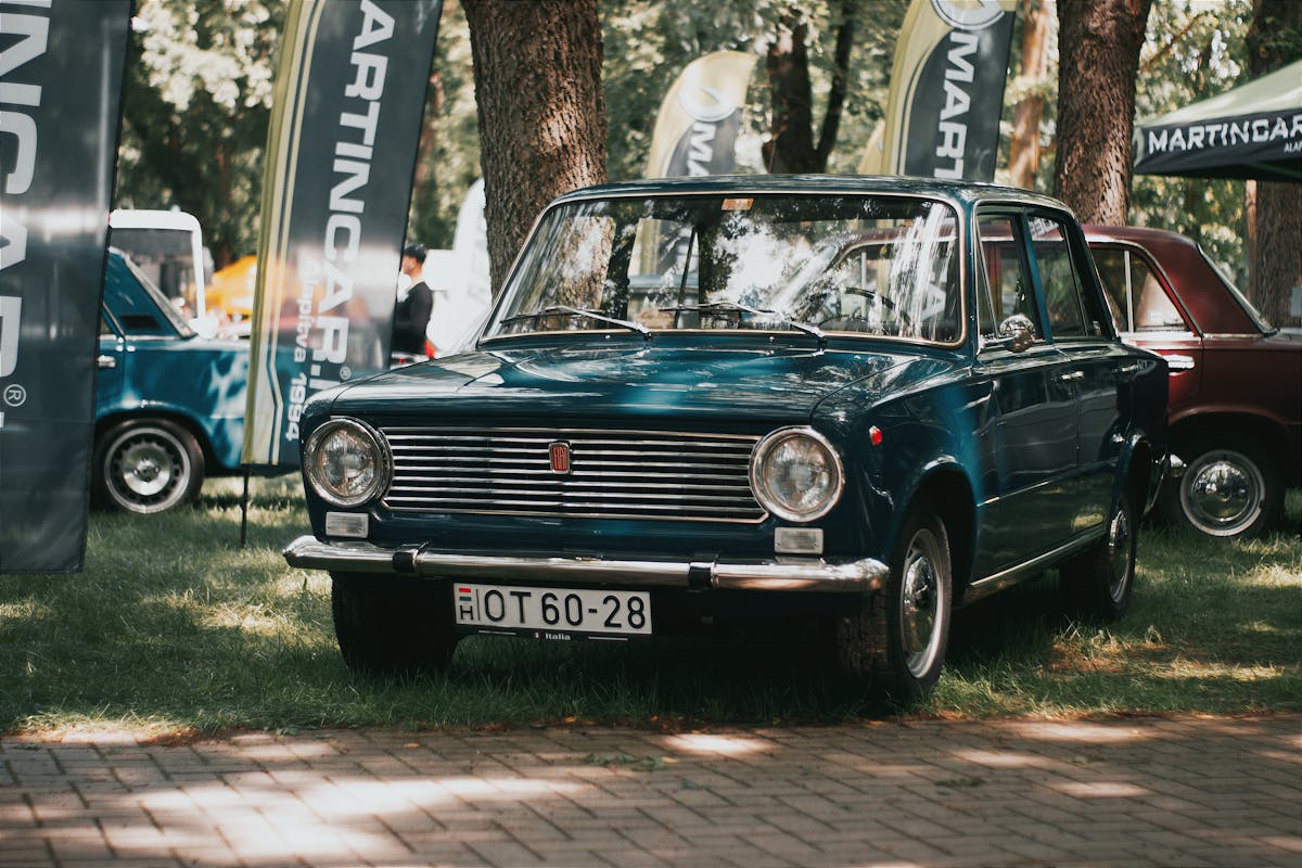 Blue Classic Fiat 124 at a Car Show