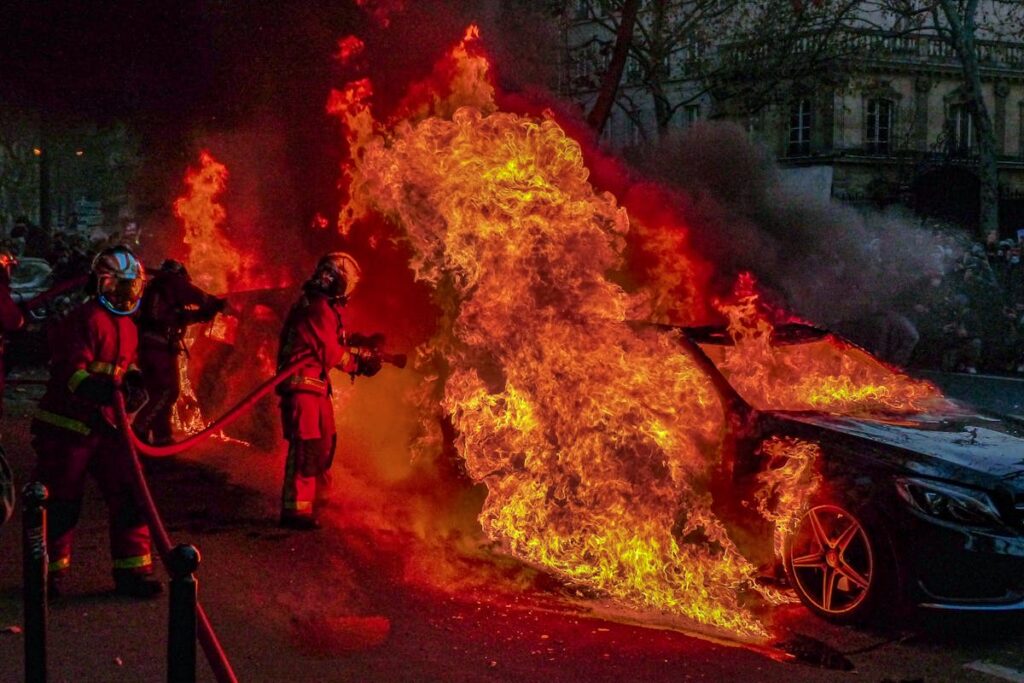 Firefighters Extinguishing a Burning Car