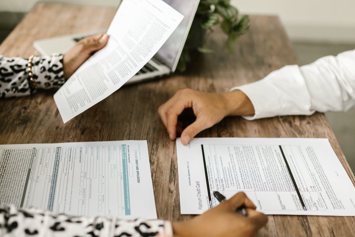 Man and Woman Sitting at Table with Papers