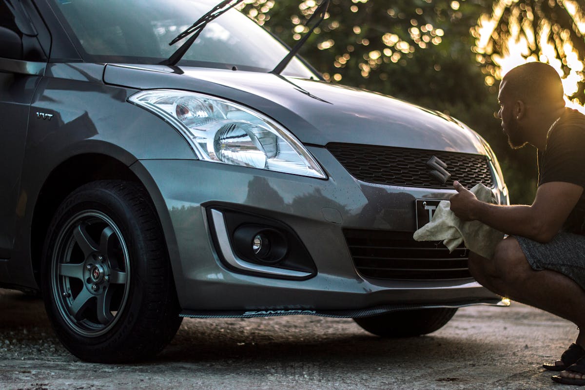 Photo of Man Cleaning His Car