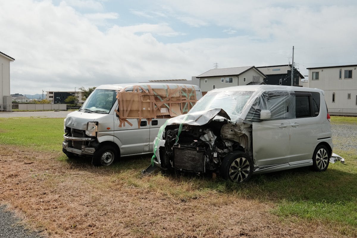 Two Damaged Vans in a Residential Area