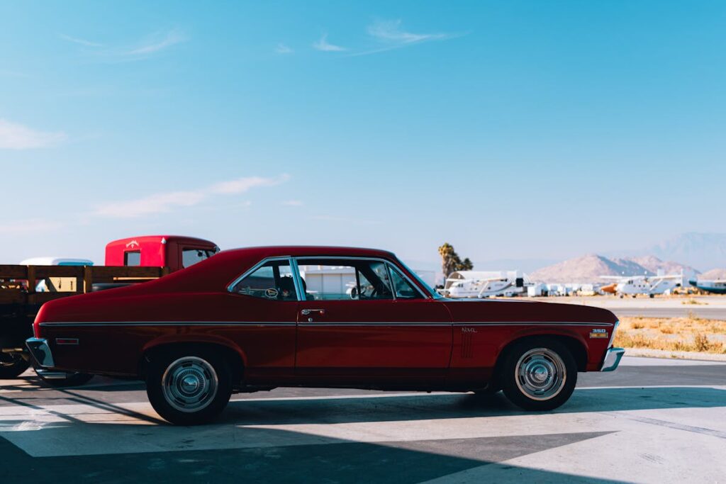 View of a Vintage Chevrolet Nova on a Parking Lot under Blue Sky