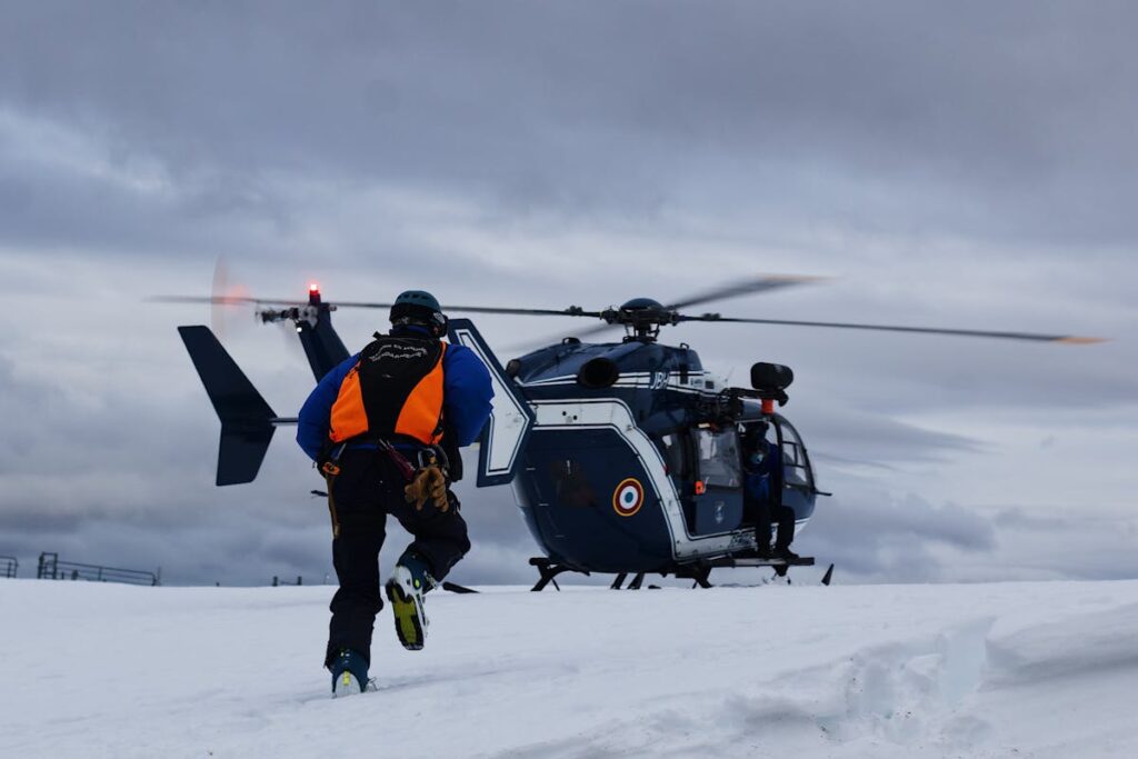 A Man in Reflective Jacket Running Towards a Helicopter