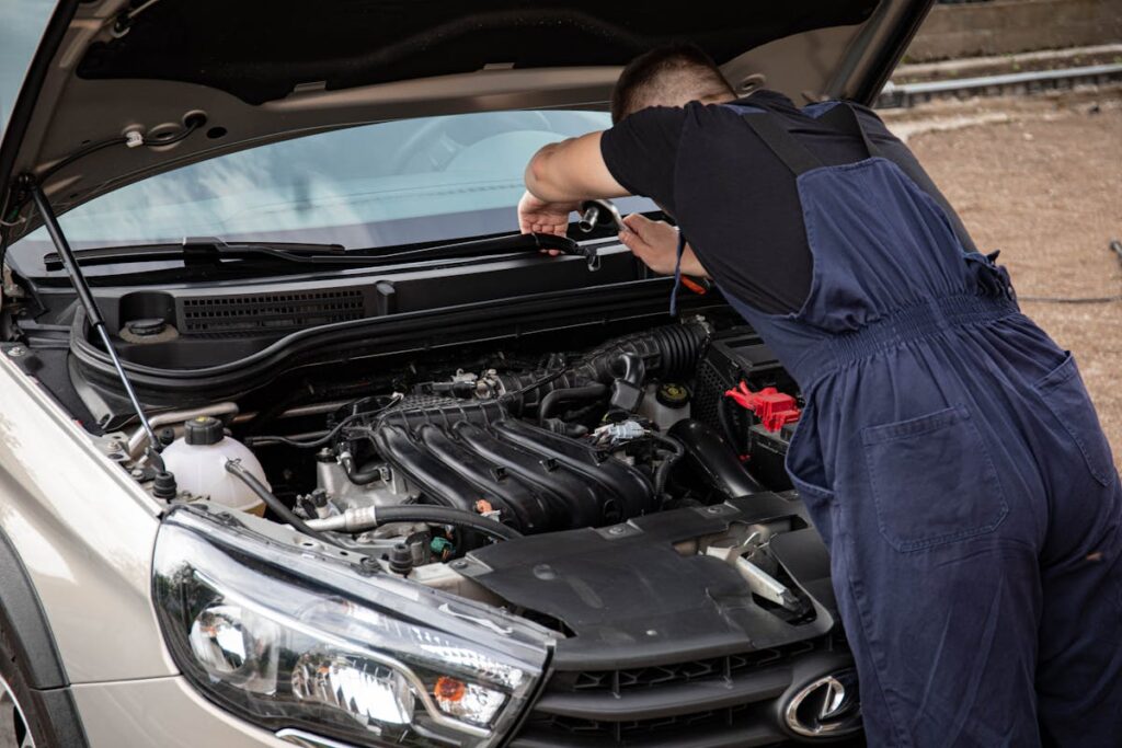 Man in Black Crew Neck T Shirt Fixing a Car