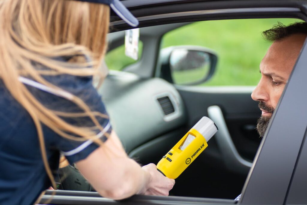 Police Officer Conducting Breathalyzer Test in Car
