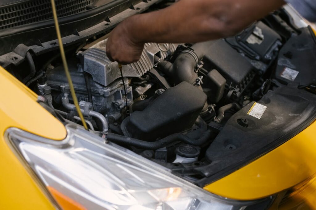 Crop ethnic mechanic revising modern taxi transport bonnet