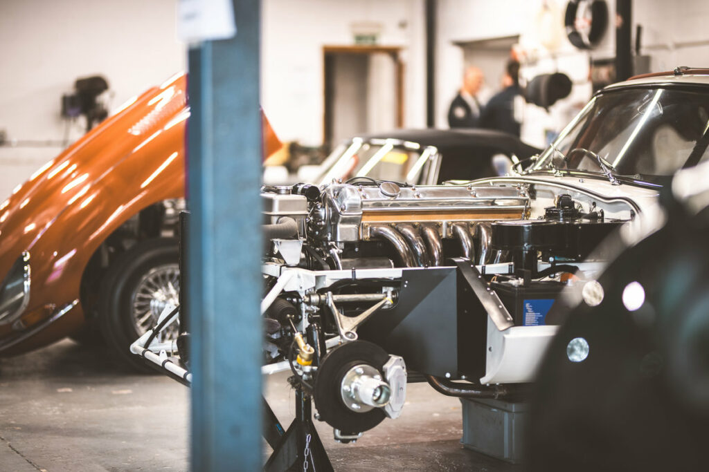 Detailed view of a vintage automobile's polished engine and components during a meticulous repair process